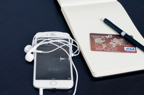 mobile-phone-and-credit-card-with-notebook-and-pen-on-table